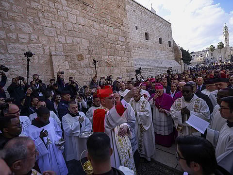 Latin Patriarch of Jerusalem Pierbattista Pizzaballa (C) leads the yearly Christmas procession outside the Church of the Nativity in Bethlehem town in the Israel-occupied West Bank on December 24, 2024. 
