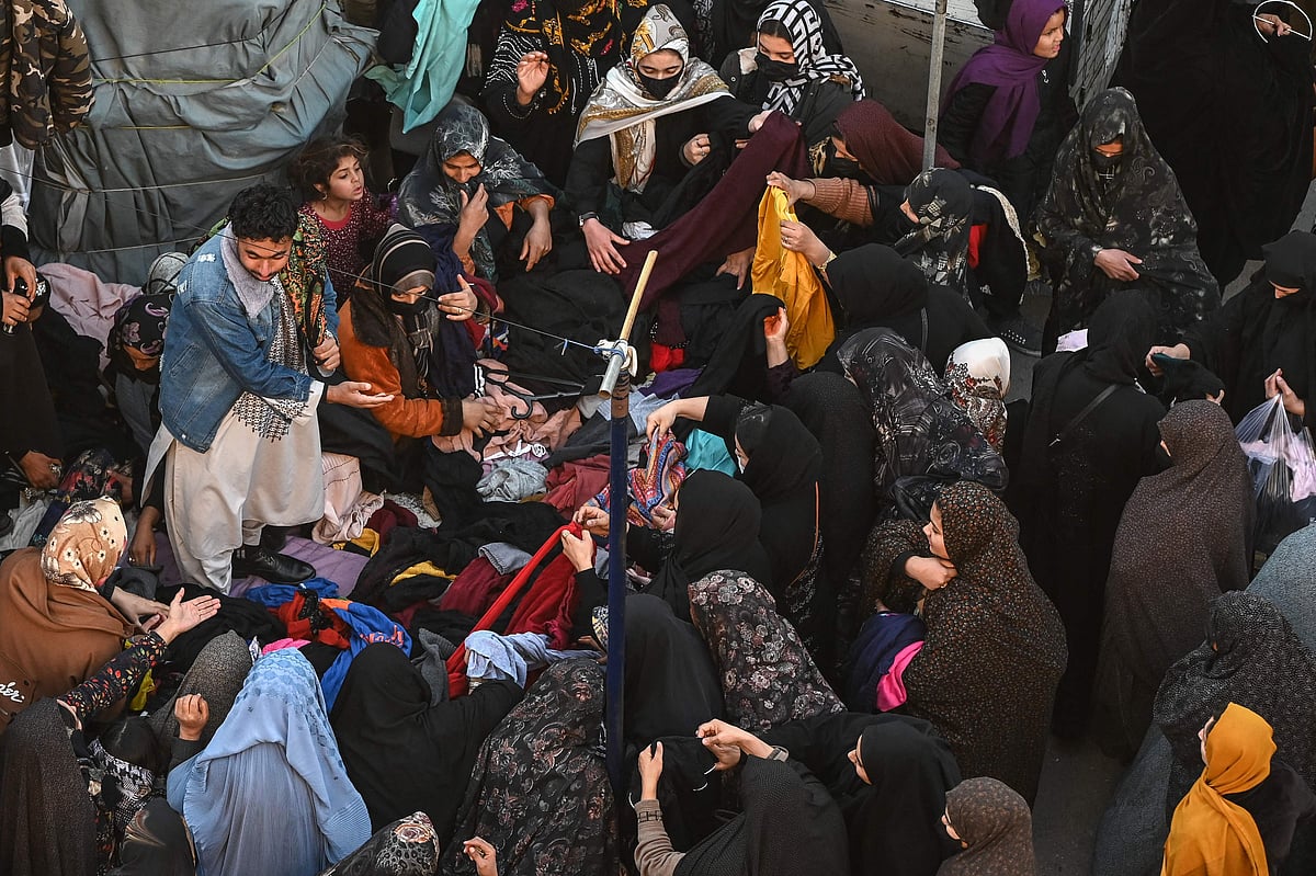 Afghan women buy clothes at a second hand market in Herat.