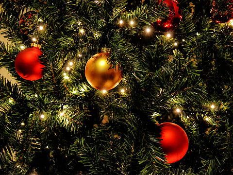 A Christmas tree with sparkling, sophisticated ornaments and glowing lights add magic to the festive season. 