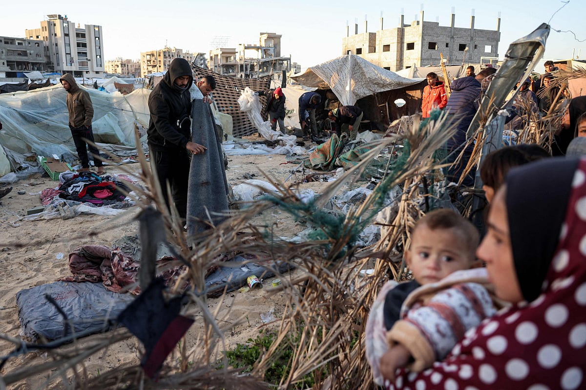 People inspect the site of reported Israeli bombardment on tents sheltering Palestinians displaced from Beit Lahia at a camp in Khan Yunis in the southern Gaza Strip on December 25, 2024.