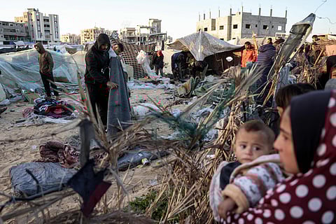 People inspect the site of reported Israeli bombardment on tents sheltering Palestinians displaced from Beit Lahia at a camp in Khan Yunis in the southern Gaza Strip on December 25, 2024.