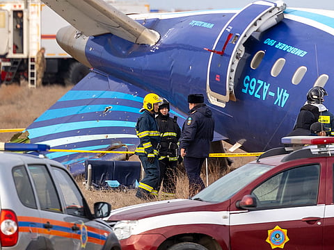 Emergency specialists work at the crash site of an Azerbaijan Airlines passenger jet near the western Kazakh city of Aktau on December 25, 2024. 