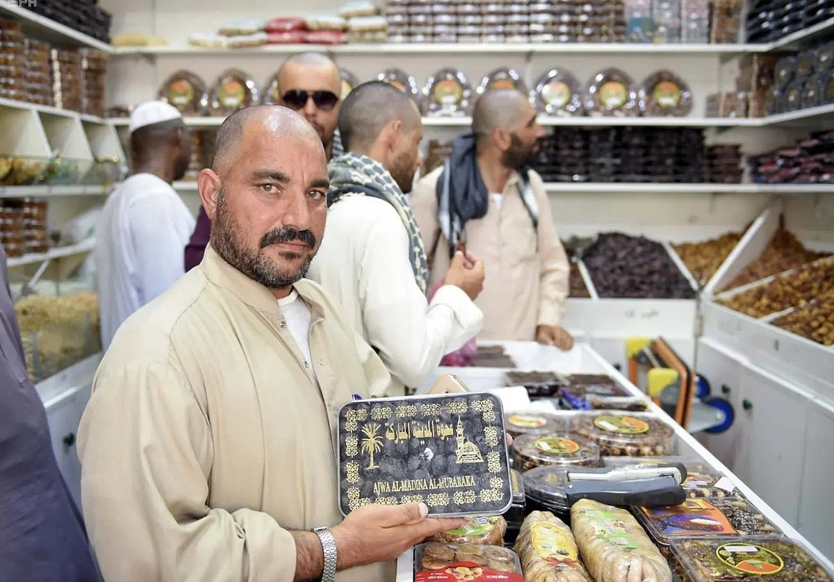 Pilgrims shop for gifts at Medina stores before departure from Saudi Arabia. 