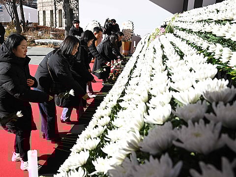 Mourners pay their respects at a memorial altar for the victims of the Jeju Air plane crash, in front of Seoul City Hall in Seoul on December 31, 2024.  