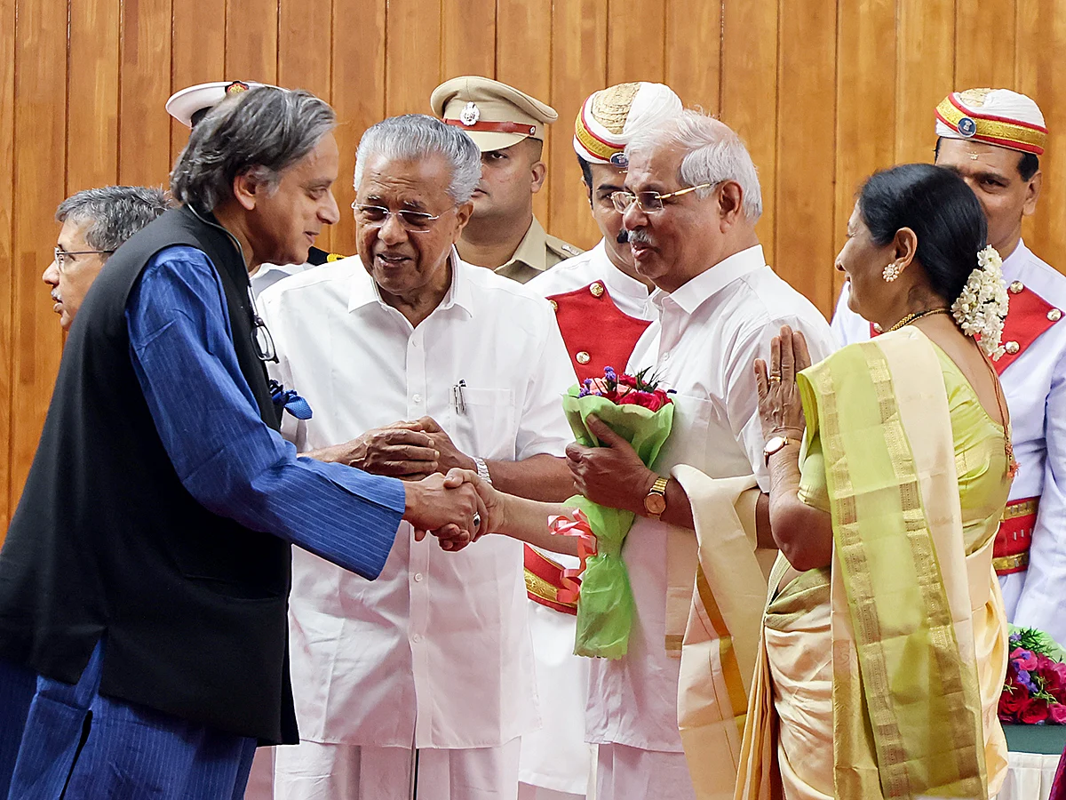 Congress MP Shashi Tharoor congratulates Kerala Governor Rajendra Arlekar during the swearing-in ceremony, in Thiruvananthapuram on Thursday, January 2, 2025. State Chief Minister Pinarayi Vijayan is also seen in the picture. 