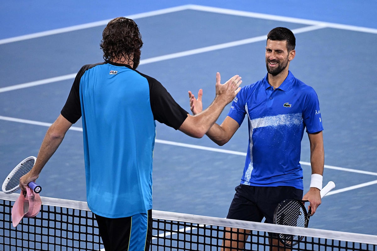 Towering American Reilly Opelka shakes hands with former world No 1 Novak Djokovic after winning their clash in Brisbane on Friday.