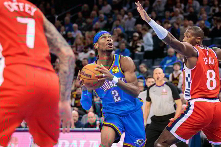 Shai Gilgeous-Alexander (centre) of Oklahoma City Thunder drives to the basket against Kris Dunn of Los Angeles Clippers during the third quarter on Thursday.