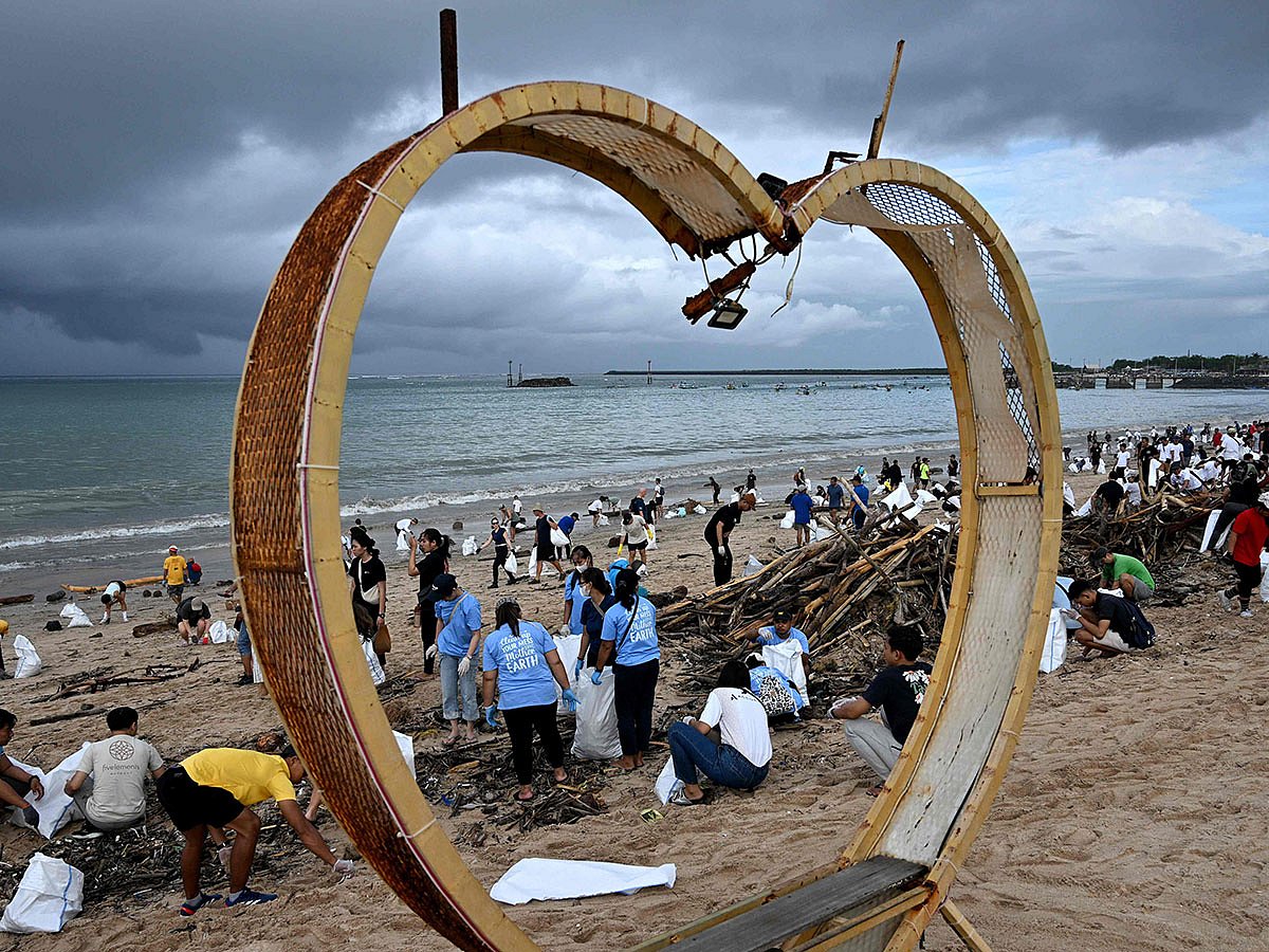 Participants and volunteers remove plastic waste and other garbage washed ashore at a beach in Kedonganan Badung regency, Indonesia's Bali island