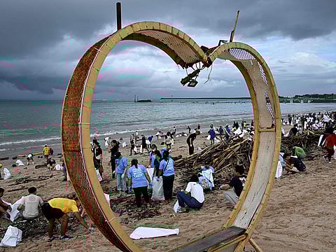 Participants and volunteers remove plastic waste and other garbage washed ashore at a beach in Kedonganan Badung regency, Indonesia's Bali island