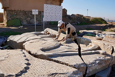 An archaeology expert catalogues destroyed archaeological artefacts at the archaeological site of Nimrud, south of Mosul, on January 3, 2025.  