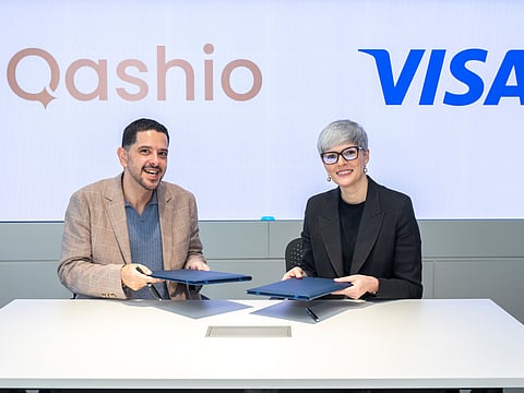 Armin Moradi (left), CEO and Co-founder of Qashio, and Salima Gutieva, Visa’s VP and Country Manager for the UAE, sign the partnership agreement