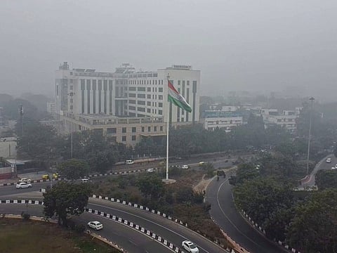 A thin layer of fog envelops the AIIMS area as the cold wave continues, in New Delhi.