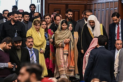 Nobel Peace Prize laureate Malala Yousafzai (centre) arrives to attend an international summit on education.