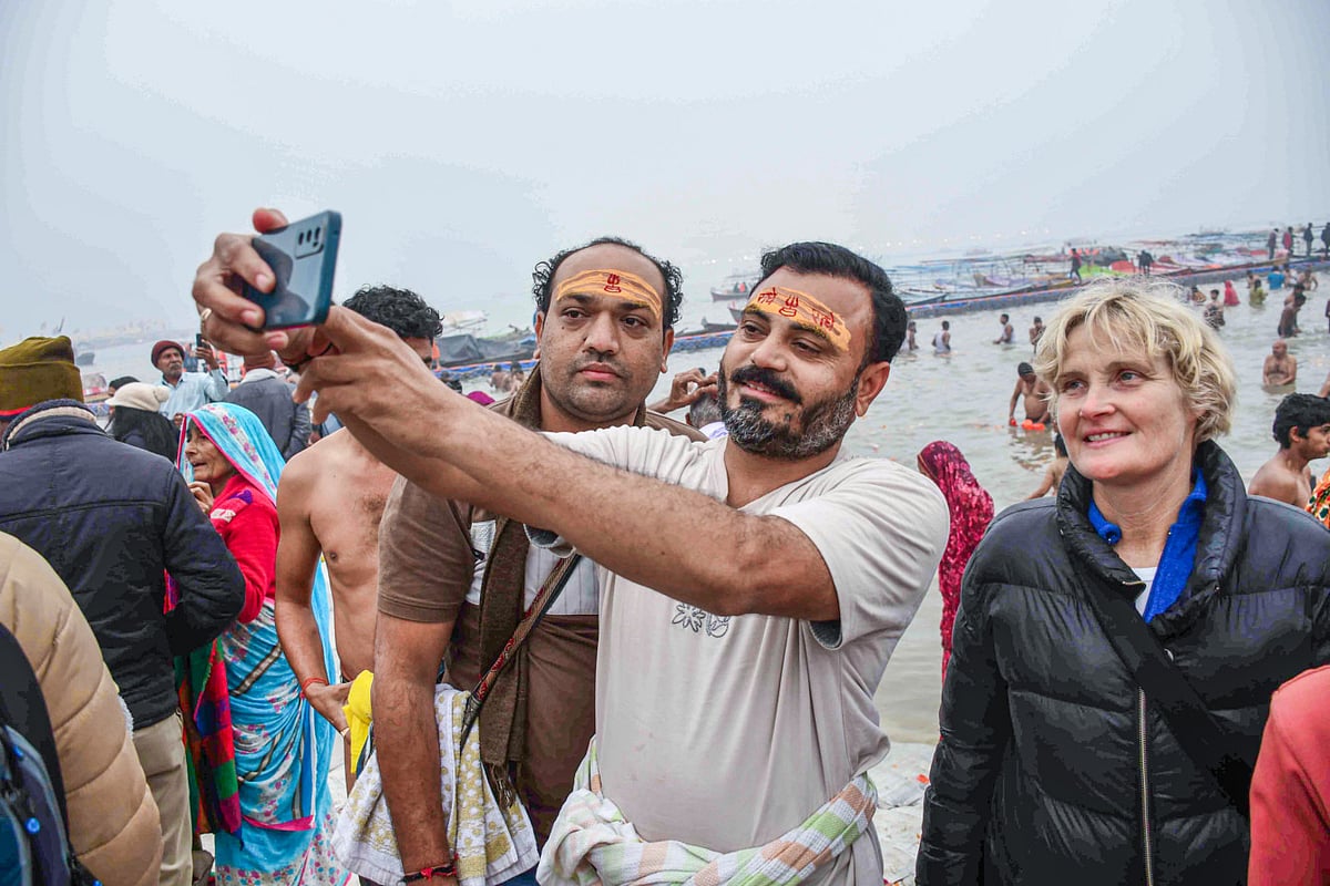 Devotees arrive to take a dip at Triveni Sangam on the occasion of ‘Paush Purnima’ at Maha Kumbh 2025, in Prayagraj on Monday.  