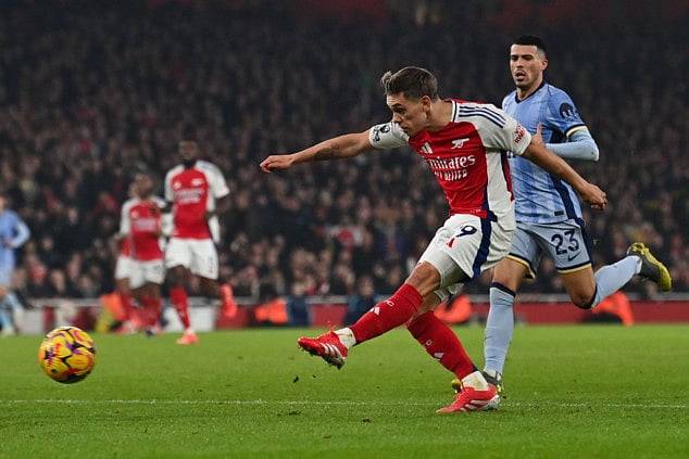 Arsenal's Belgian midfielder Leandro Trossard shoots and scores his team second goal during the English Premier League football match against Tottenham Hotspur at the Emirates Stadium in London on January 15.