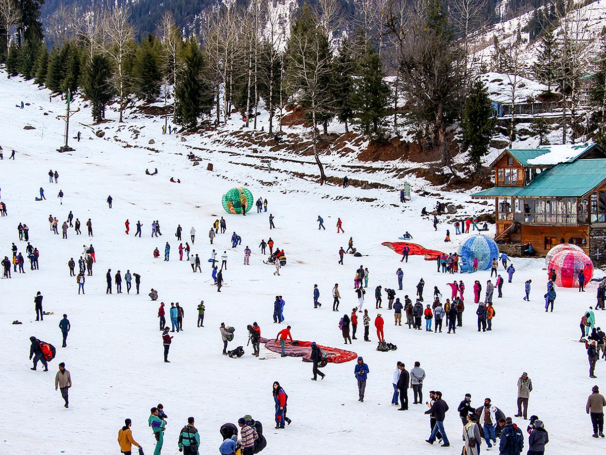 Tourists enjoy after fresh snowfall, at the Solang Valley in Manali.
