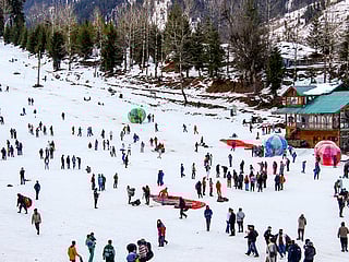 Tourists enjoy after fresh snowfall, at the Solang Valley in Manali.