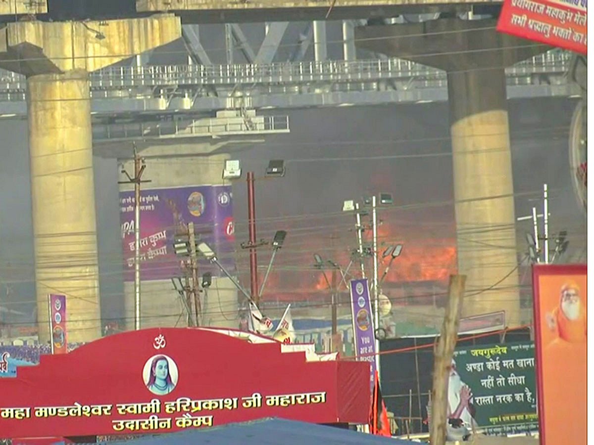 Flames and smoke billow out after a fire broke out at the Maha Kumbh Mela in Prayagraj on Sunday.  