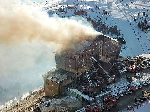 This handout photograph released by the Demiroren News Agency (DHA) on January 21, 2025, shows an aerial picture of a fire on the fourth floor of the 11-storey hotel in Bolu's Kartalkaya ski resort