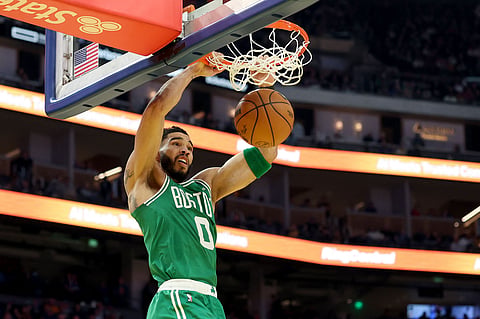Jayson Tatum of Boston Celtics dunks the ball against Golden State Warriors during the first half at Chase Center on Monday.