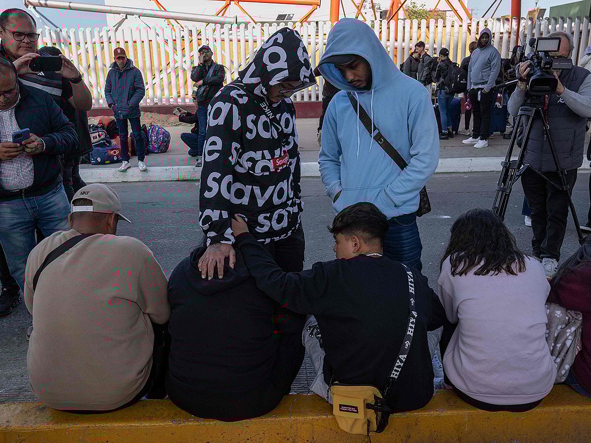 Asylum seekers wait for news on their CBP One appointments with US authorities as they expect to cross to the US, at El Chaparral port in Tijuana, Baja California state, Mexico, on January 20, 2025.  
