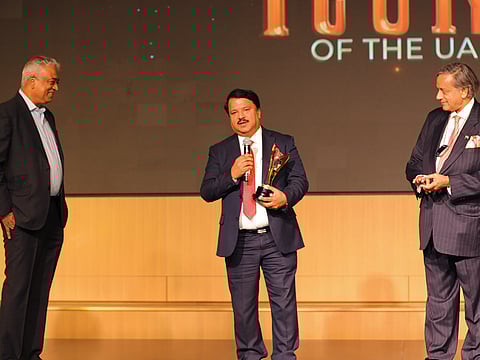 Dr K.P. Hussain, Chairman, FMC Network UAE, receiving the Icons of the UAE Award 2023 from Shashi Tharoor