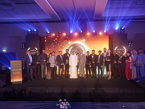 Ismail Al Naqi, Director General of the Free Zones Authority of Ajman, with awards winners at the inaugural edition of the Ajman Free Zones Excellence Awards, held at Fairmont the Palm