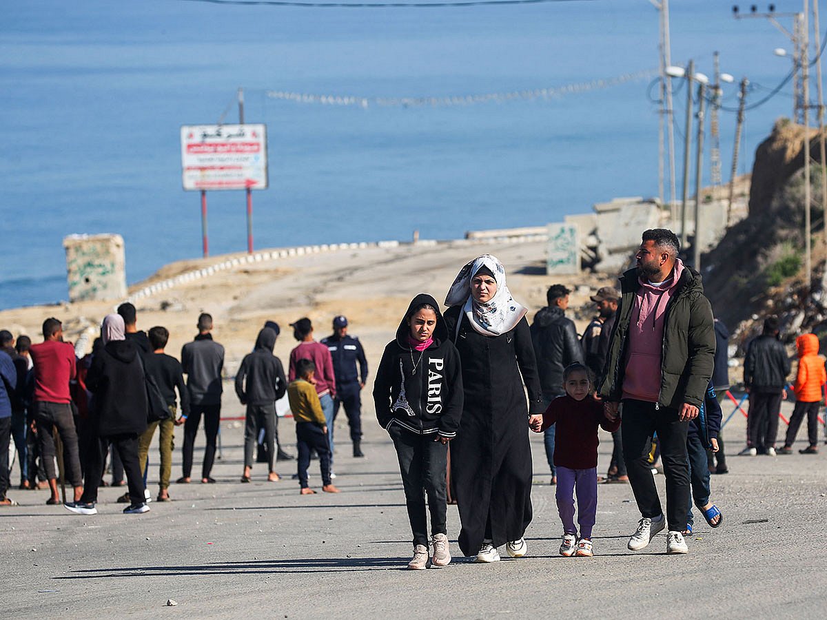 Displaced people arrive near a roadblock on Salah Al Din Street in Nuseirat to return to their homes in the northern part of the Gaza Strip.