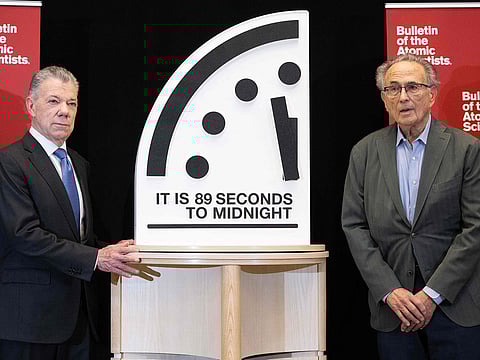 Former President of Colombia Juan Manuel Santos (L), chair of the Elders, and Robert Socolow (R), professor emeritus at Princeton University and member of the Atomic Scientists' Science and Security Board, unveil the Doomsday Clock at 89 seconds to midnight, January 28, 2025.