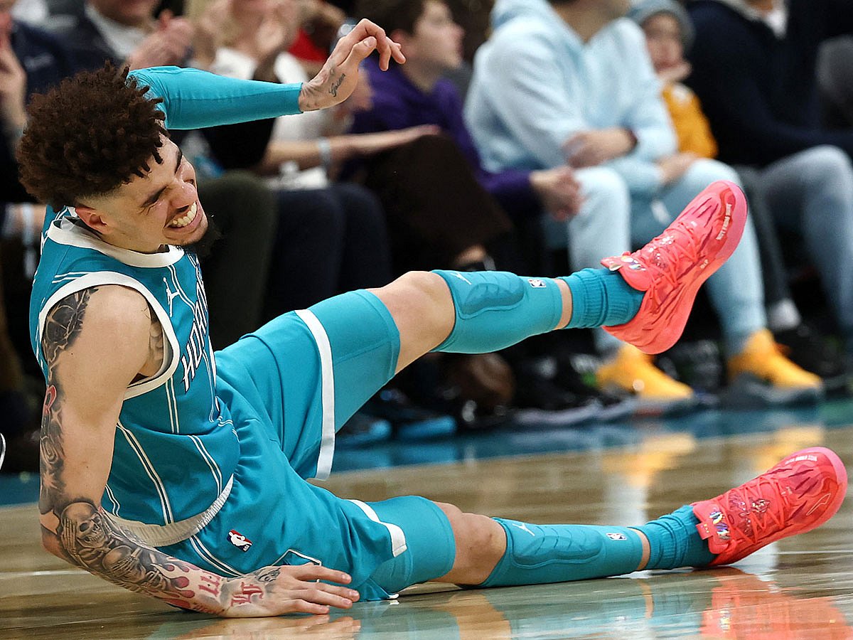 LaMelo Ball #1 of the Charlotte Hornets falls to the ground following a left ankle sprain during the second quarter of the game against the Los Angeles Lakers at Spectrum Center.