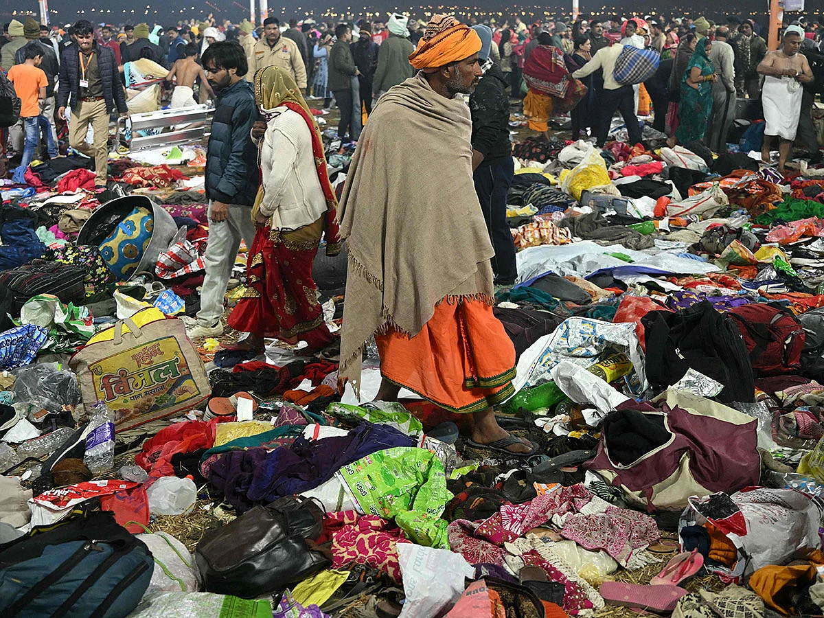 Pilgrims look for their belongings at the site of a stampede amid the ongoing Maha Kumbh Mela festival in Prayagraj.