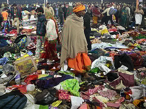 Pilgrims look for their belongings at the site of a stampede amid the ongoing Maha Kumbh Mela festival in Prayagraj.