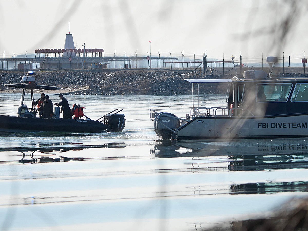 Emergency response units search near the crash site of an American Airlines plane on the Potomac River after an accident last night while on approach to Reagan National Airport on January 30, 2025 in Arlington, Virginia.