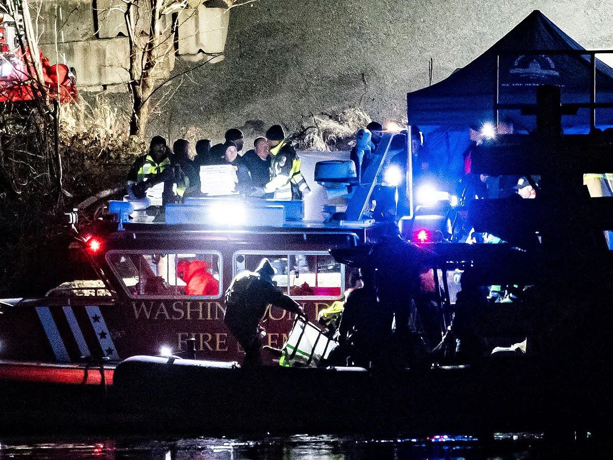 Emergency response units conduct search and rescue operations in the Potomac River near Ronald Reagan Washington Airport in Washington, DC.