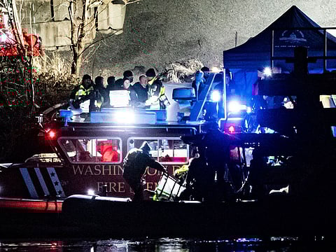 Emergency response units conduct search and rescue operations in the Potomac River near Ronald Reagan Washington Airport in Washington, DC.