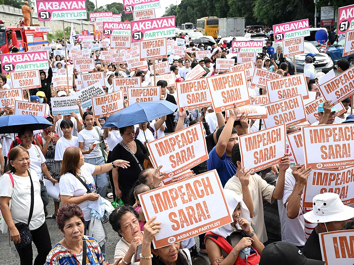 Protesters holding placards shout slogans during a rally at the People Power monument in Manila on January 31, 2025, in support of the impeachment of Philippine Vice-President Sara Duterte. 