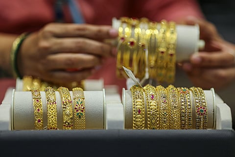 Gold bracelets for sale at a Kalyan Jewellers India store.