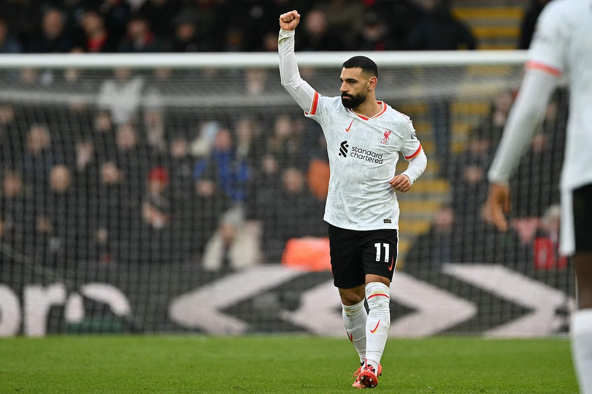 Liverpool's Egyptian striker #11 Mohamed Salah celebrates after scoring the opening goal from the penalty spot during the English Premier League football match between Bournemouth and Liverpool at the Vitality Stadium in Bournemouth, southern England on February 1, 2025.