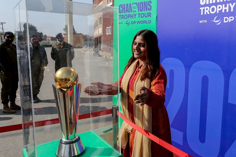 A woman looks at the 'ICC Champions Trophy' displayed outside the Multan Cricket Stadium during a ceremony in Multan on February 2.