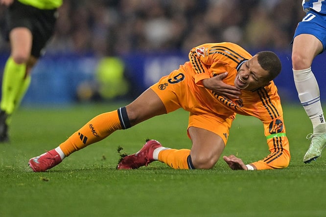 Real Madrid's French forward Kylian Mbappe grimaces after being fouled during the Spanish league football match against RCD Espanyol at the RCDE Stadium in Cornella de Llobregat on February 1.