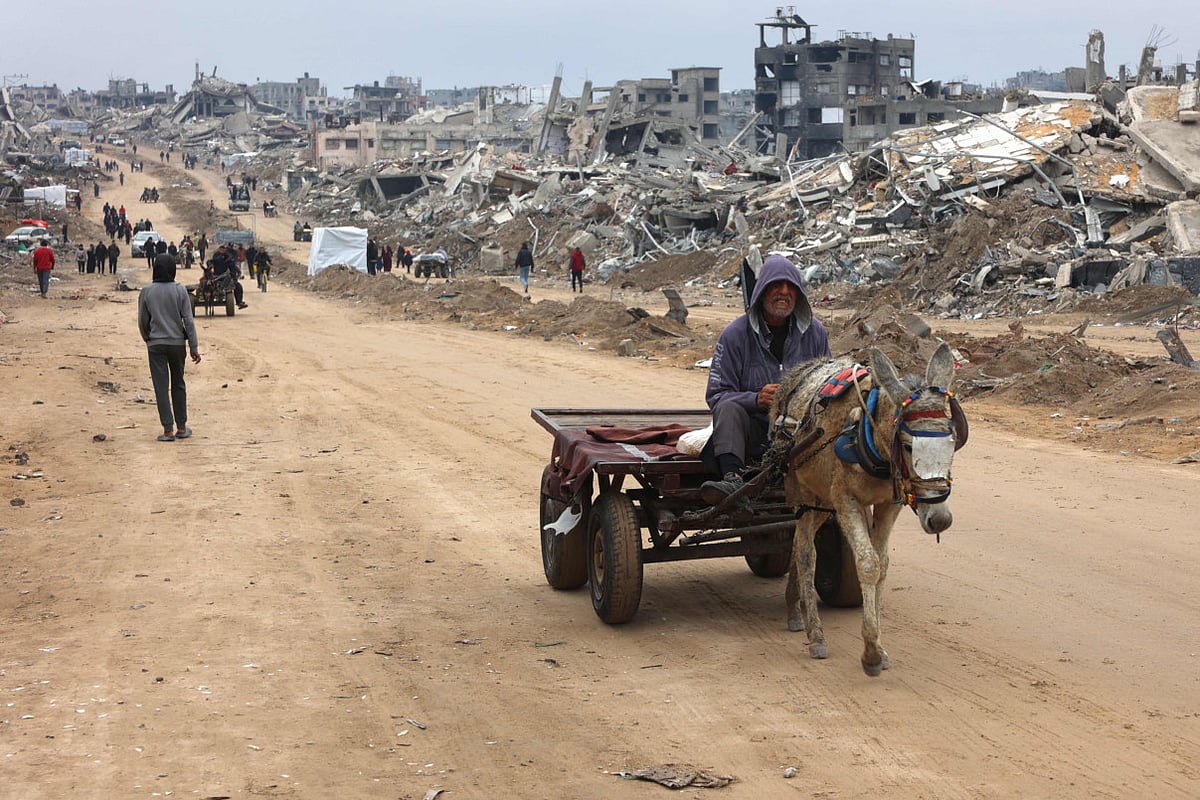 A man rides a donkey-pulled cart past the rubble of destroyed buildings at Saftawi street in Jabalia, in the northern Gaza Strip, on February 5, 2025 during a ceasefire deal in the war between Israel and Hamas.  