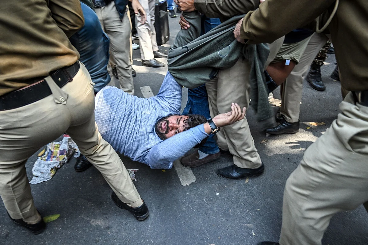 A demonstrator is detained during an Indian Youth Congress protest in New Delhi on February 6, 2025, against the deportation of undocumented Indian migrants by the US in shackles. 