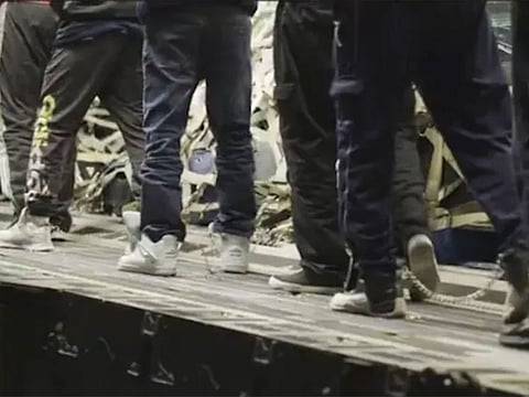 Set to dramatic music, the video showed migrants being marched aboard the C-17 transport plane, shackled at the legs, shuffling like hardened criminals.  