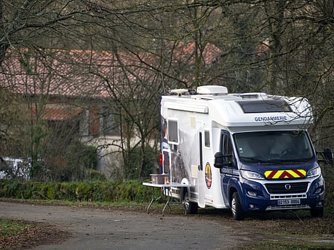 This photograph taken in Villefranche-de-Rouergue, southwestern France, on February 7, 2025, shows a French Gendarmerie's van parked at the entrance of the house of a British couple, aged in their sixties, who were found dead on February 6, 2025.