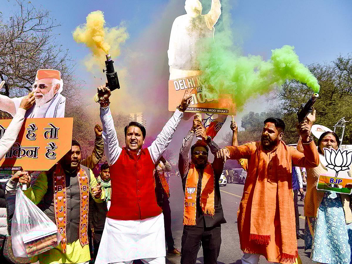 Bharatiya Janata Party (BJP) supporters celebrate the party's win in the Delhi Assembly elections, at party headquarters in New Delhi on Saturday.