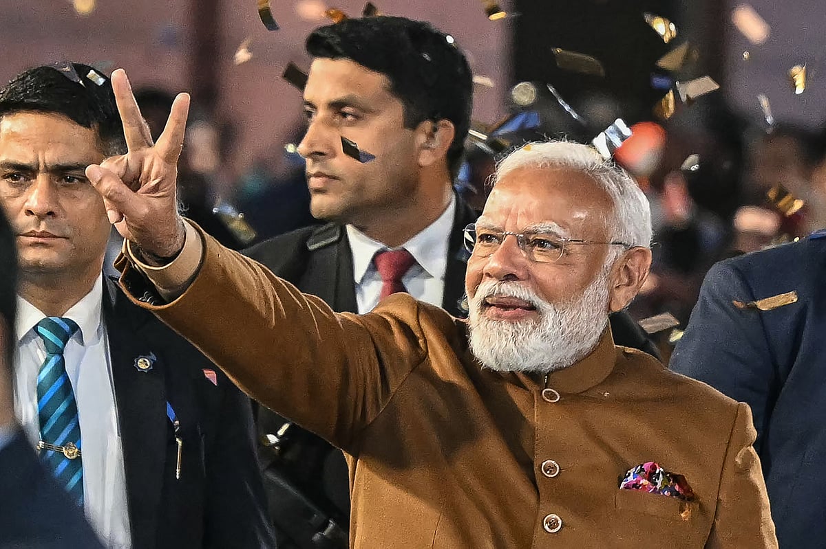 India's Prime Minister Narendra Modi flashes victory sign as he arrives at the Bharatiya Janata Party (BJP) headquarters to celebrate the party's win in the Delhi legislative assembly election in New Delhi on February 8, 2025.