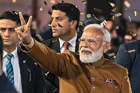 India's Prime Minister Narendra Modi flashes victory sign as he arrives at the Bharatiya Janata Party (BJP) headquarters to celebrate the party's win in the Delhi legislative assembly election in New Delhi on February 8, 2025.