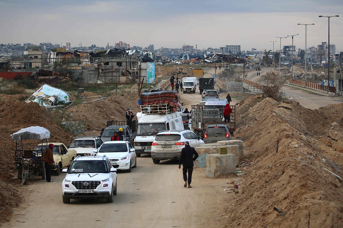 Displaced Palestinians cross the Netzarim corridor as they make their way to the northern parts of the Gaza Strip on February 9, 2025.  