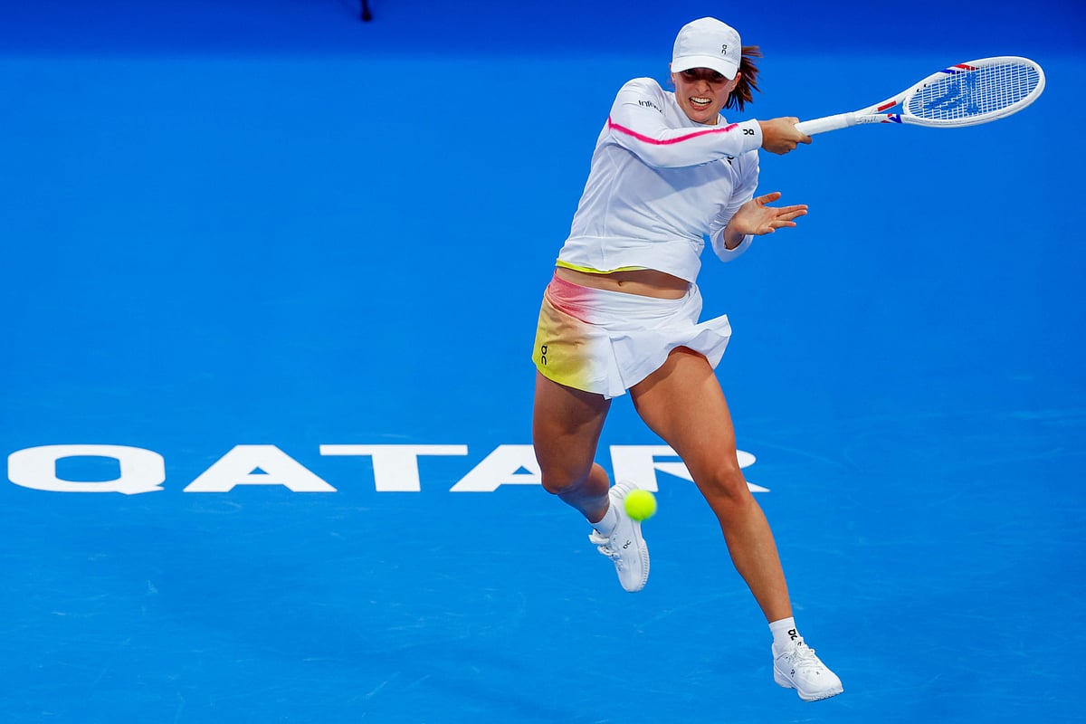 Iga Swiatek of Poland returns the ball to Maria Sakkari of Greece during their 2025 WTA Qatar Open match at the Khalifa International Tennis Complex in Doha on February 10.