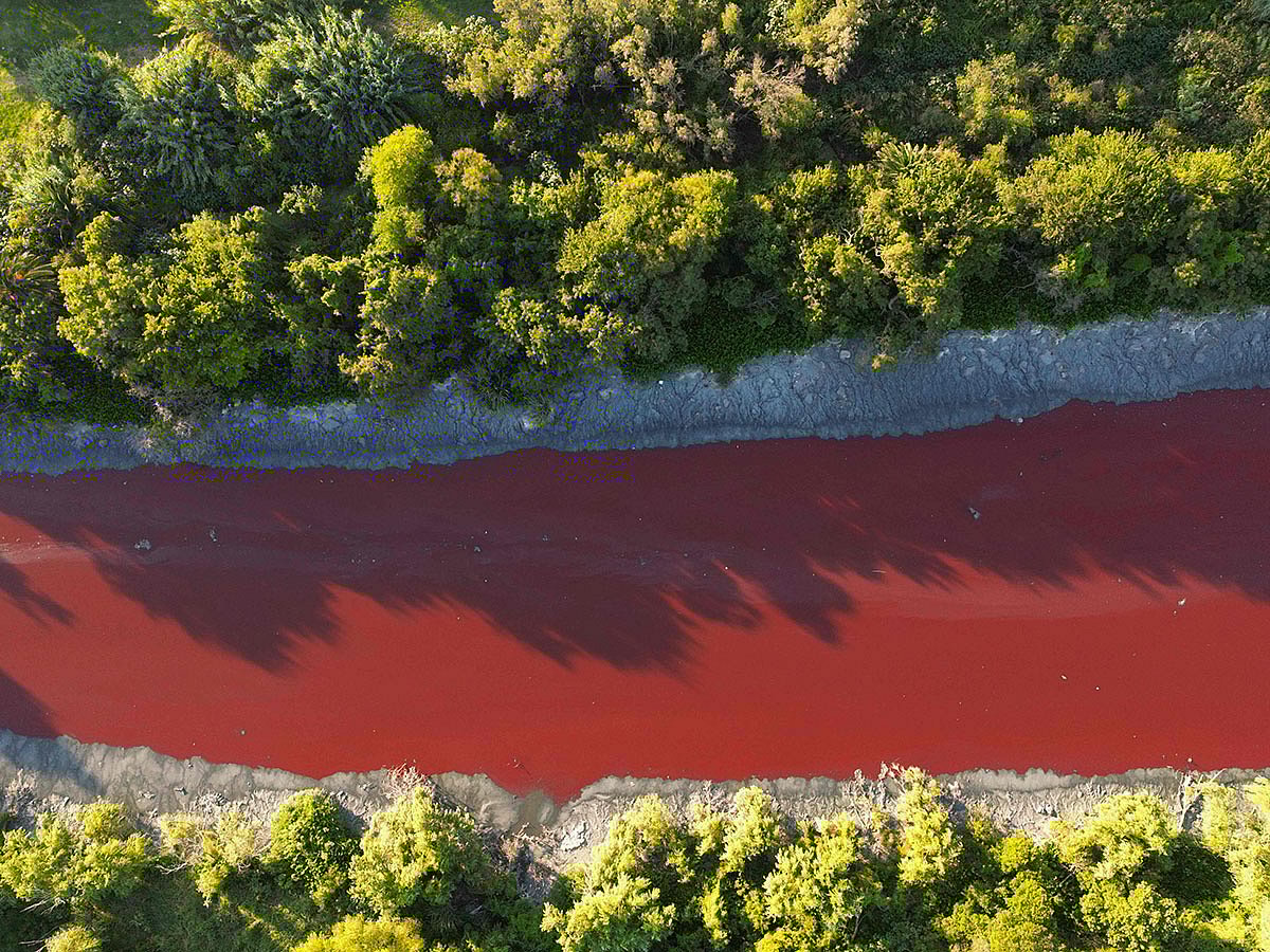 An unusual reddish color of the Sarandi Canal seeping into the Rio de la Plata River in Sarandi, Avellaneda in the outskirts of Buenos Aires.